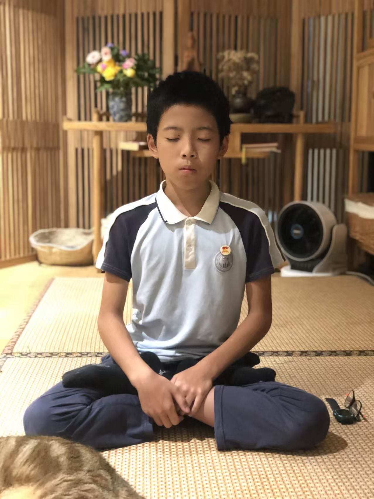Jeffrey as a child, sitting cross-legged in meditation on tatami mats