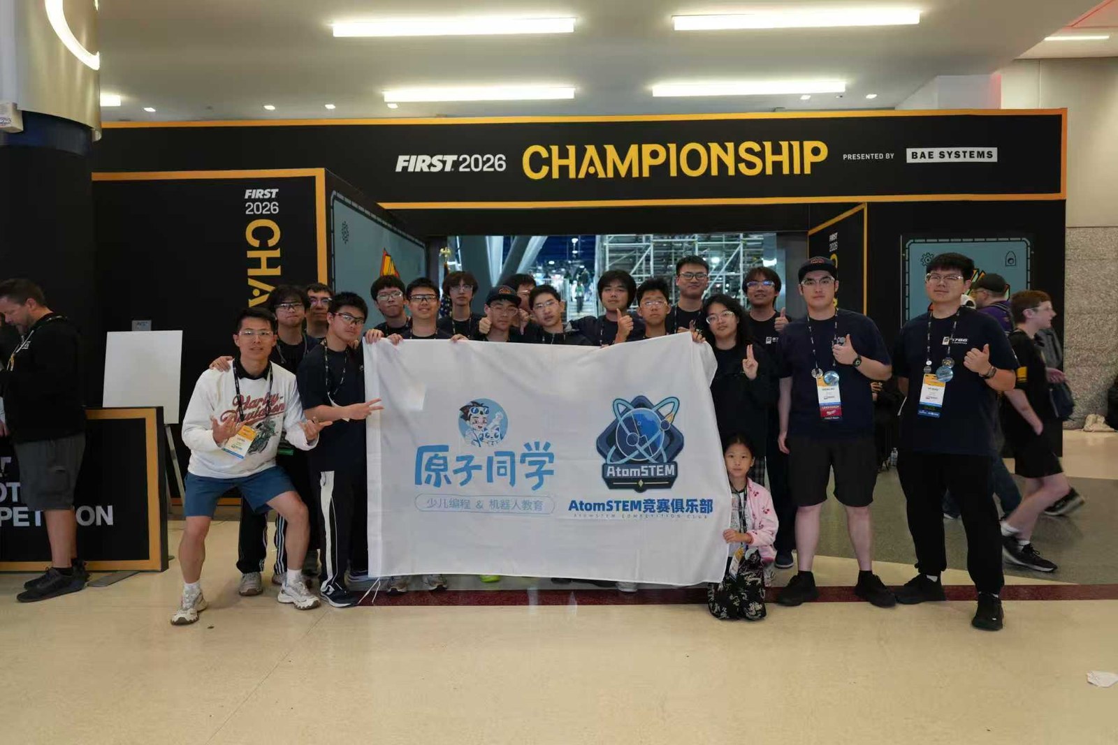 Team 6766 group photo with the AtomStorm banner at the FIRST World Championship in Houston