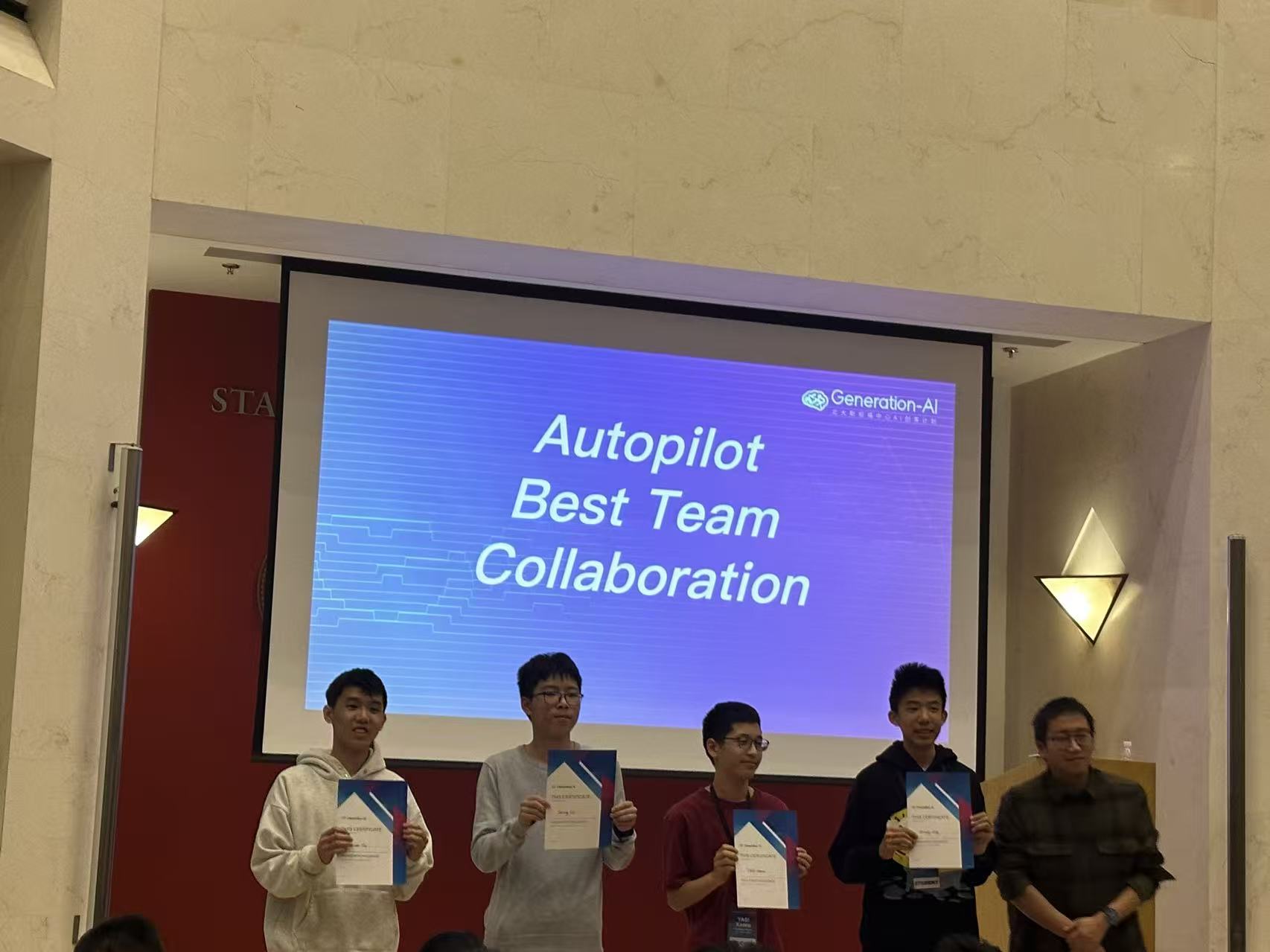 Receiving the Autopilot Best Team Collaboration award on stage at Generation-AI