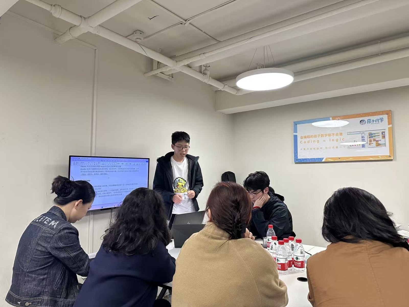 Coaching Grade-10 students during a classroom FRC training session